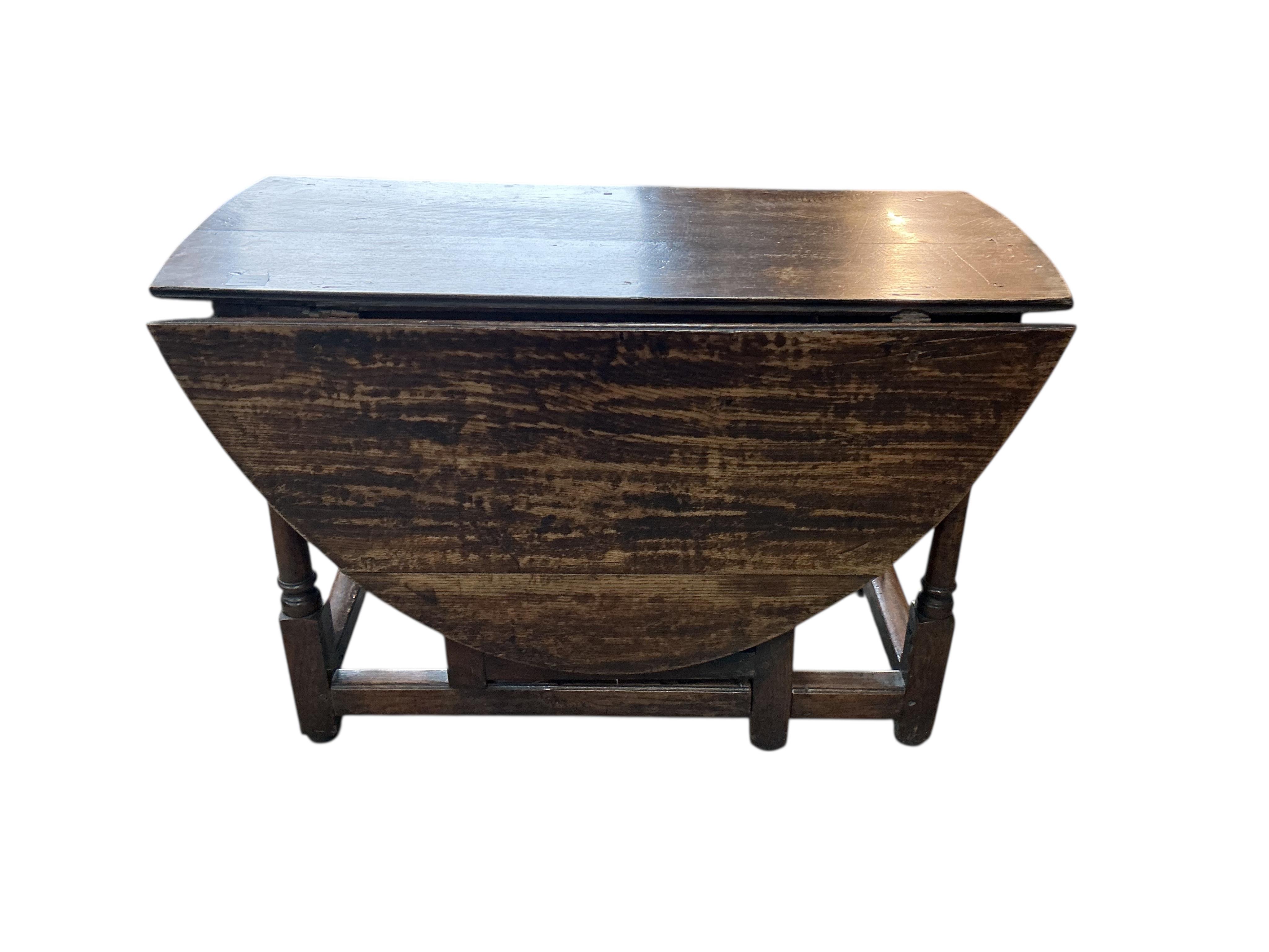 An early 18th century oak gateleg table, width 104cm, depth 47cm, height 69cm